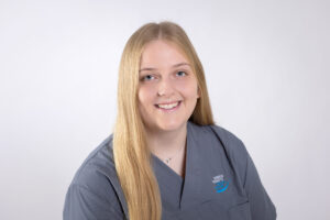 Annika Kuhlberg mit langen blonden Haaren lächelt und trägt graublaue Kleidung